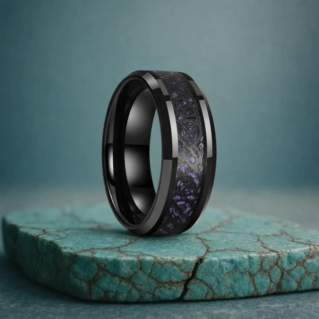 The Torque, an 8mm polished black tungsten carbide band with a carbon fibre inlay, standing upright on a turquoise veined mineral slab