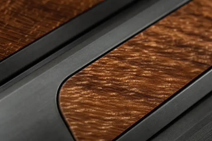 Macro of koa wood grain inset in a dark tungsten channel