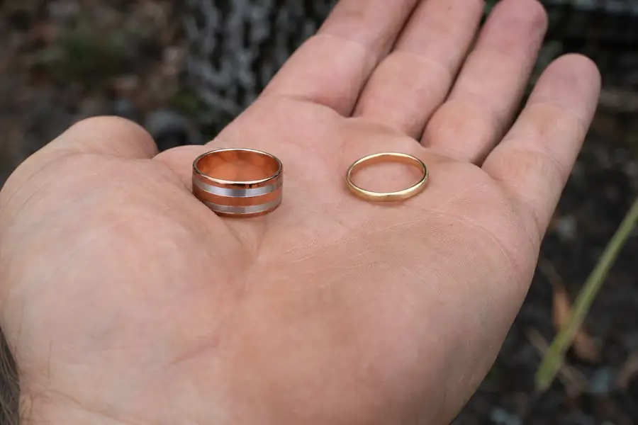 A hand weighing two rings, one in each palm
