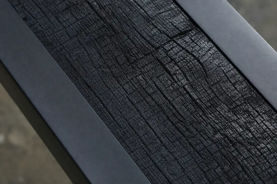 Charred oak grain set into a black tungsten channel